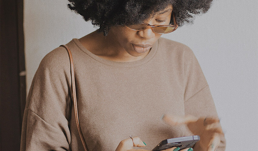 A lady staring at her mobile phone